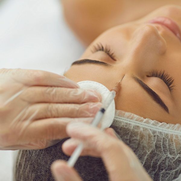 woman receiving facial fillers in forehead