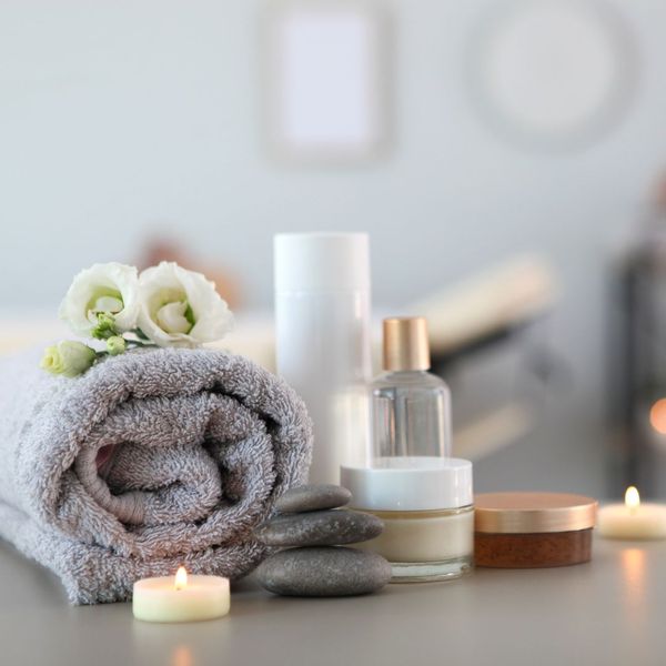 towel, candle, and skin care products at spa