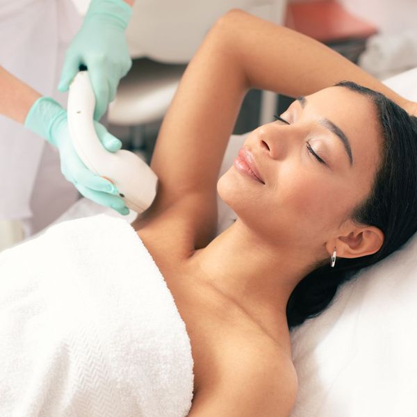 woman receiving laser hair removal on underarms