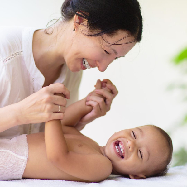 happy mother playing with her baby