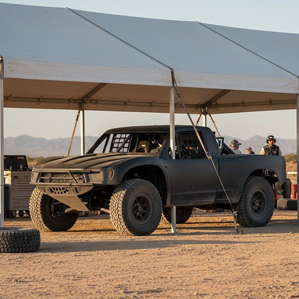 A group of racers and mechanics confidently celebrating by their vehicle in a pit area. The Benefits of Cryo Treatment for Off-Road and MX Racing BB Image 4.jpg