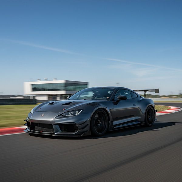 A sleek, modified car with aerodynamic components is shown from a low angle on a race track, ready to speed. Maximizing Vehicle Performance BB Image 4.jpg