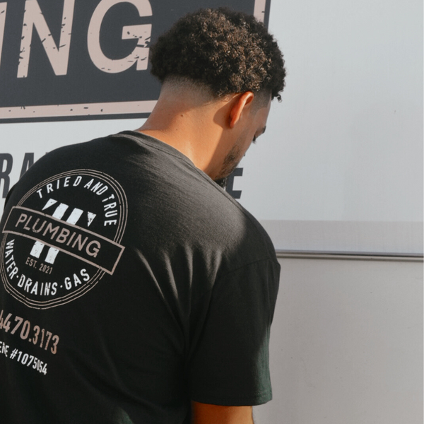 wearing shirt Sewer Camera Inspections plumbing services.png