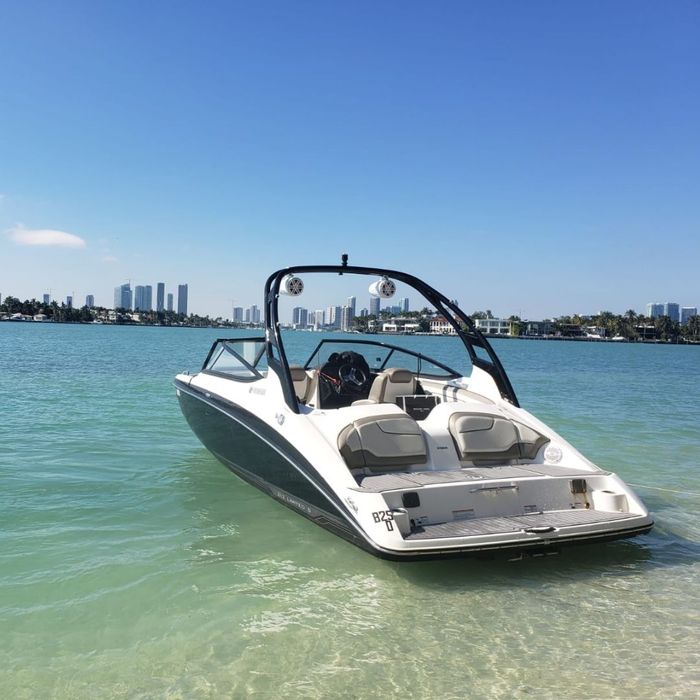 small boat with city in background