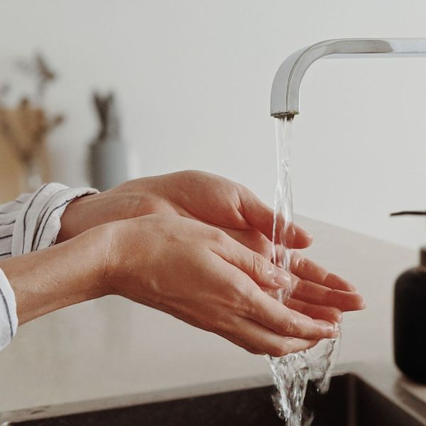 washing hands in water from sink washing hands in water from sink