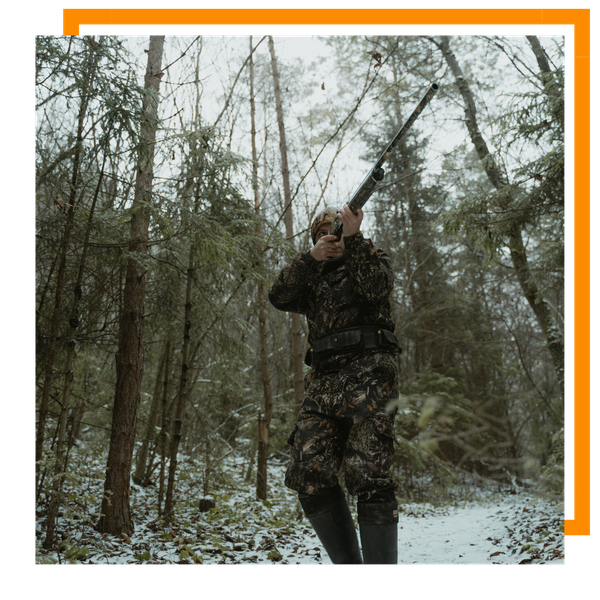 hunter walking through mountains
