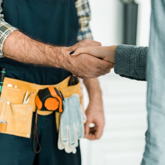 Contractor shaking hands with a person. 