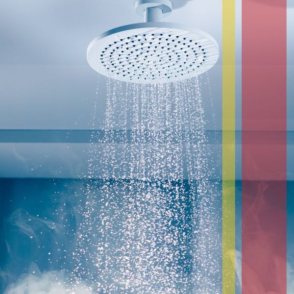 Hot, steaming water coming out of a shower head.