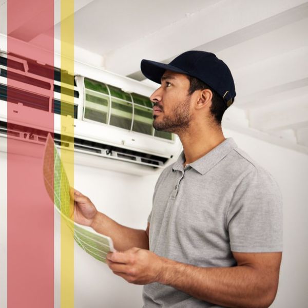 AC Technician inspecting a residential AC unit.