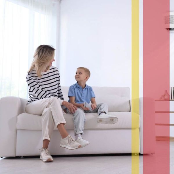 Mom and son sitting in a comfortable home with AC