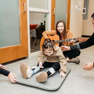 using guitar for music therapy with girl using guitar for music therapy with girl