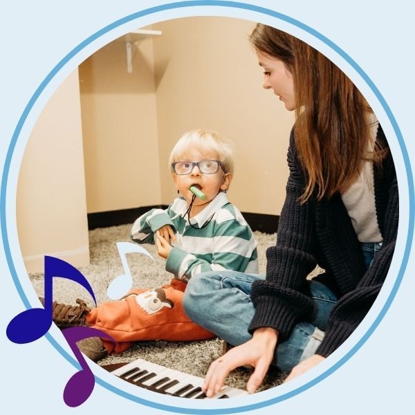 music therapy with young boy using keyboard