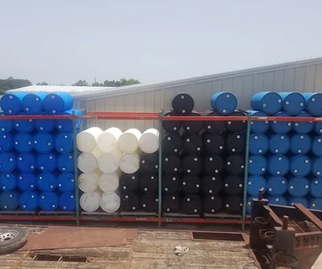Stacks of different colored plastic drum containers