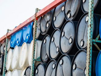 Stacks of different colored plastic drum containers