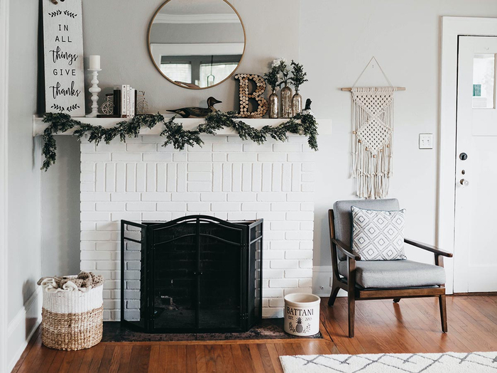 Fireplace in living room with painted white brick