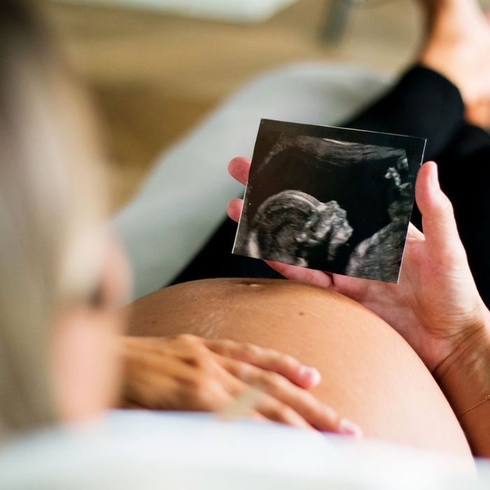 mom-to-be holding ultrasound