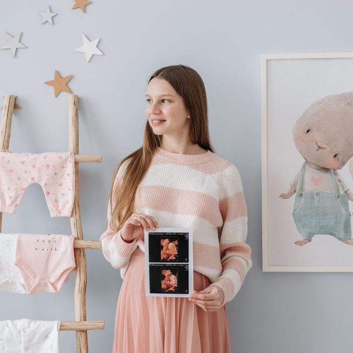 Mom to be in a nursery 