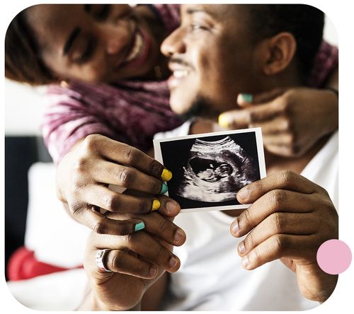 happy couple holding up ultrasound