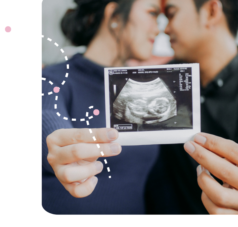 couple holding ultrasound picture