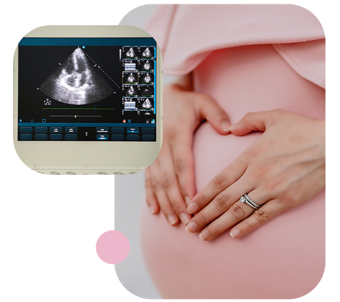 woman in pink dress making heart over her belly with her hands