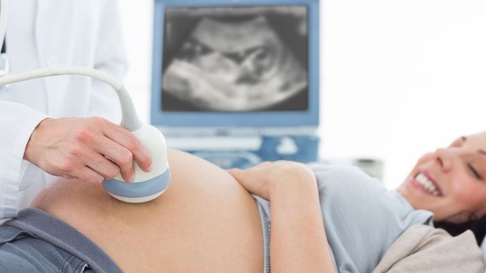 Woman smiling during ultrasound