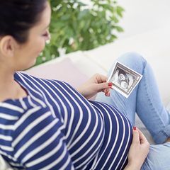 woman looking at picture of her ultrasound