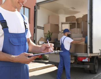 moving crew members loading trucking and checking off list