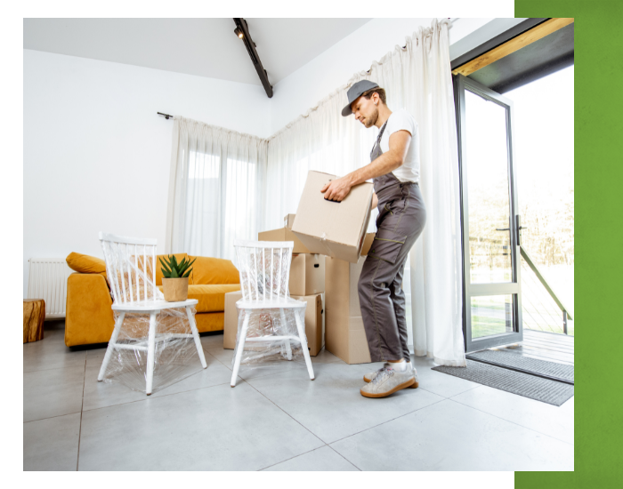 Moving crew member bring box into a house