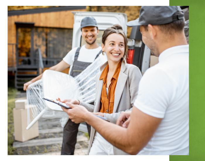 Woman smiling going over checklist with moving crew