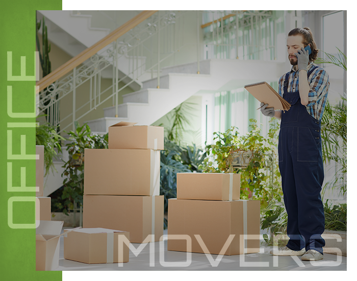 Mover on the phone in office with boxes