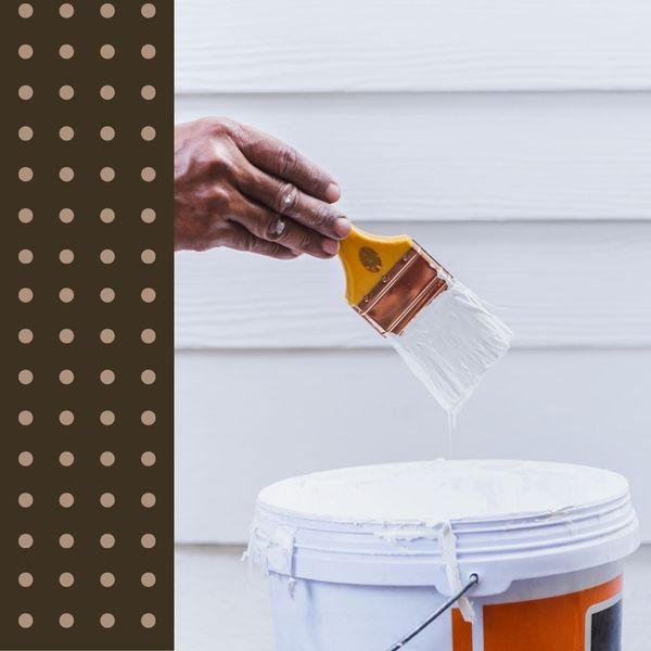 a paintbrush dipped in white paint exterior paint 50 50.jpg