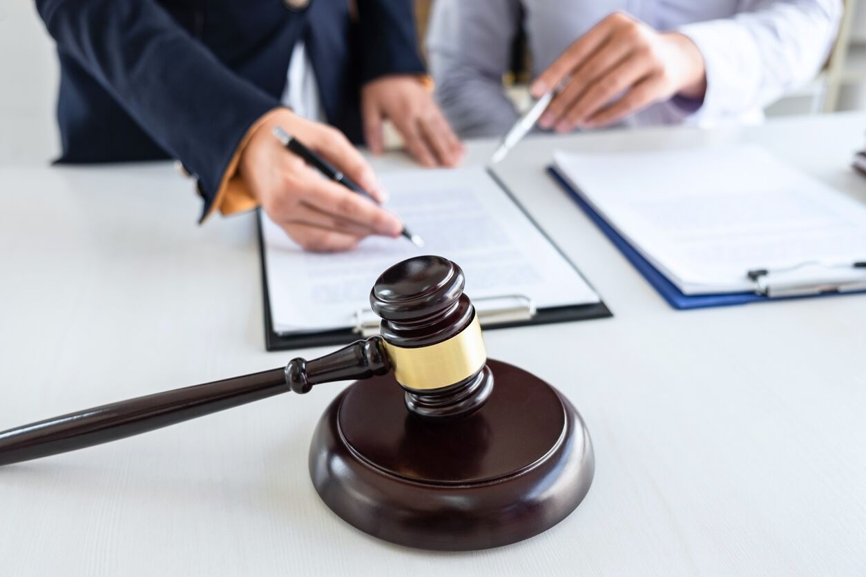 gavel, attorneys looking over clipboards