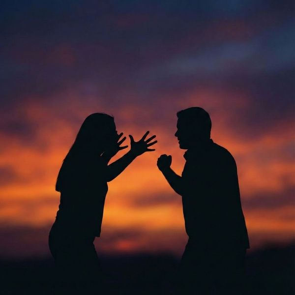 Conceptual silhouette of a heated argument representing simple assault charges.