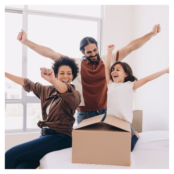 happy family unpacking moving boxes