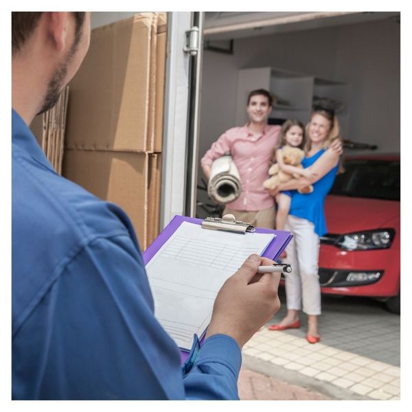 smiling homeowners working with movers