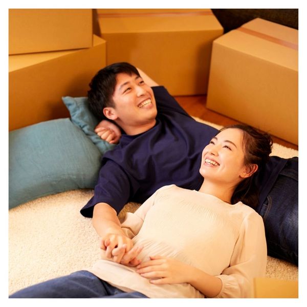 happy couple relaxing after an easy move surrounded by moving boxes