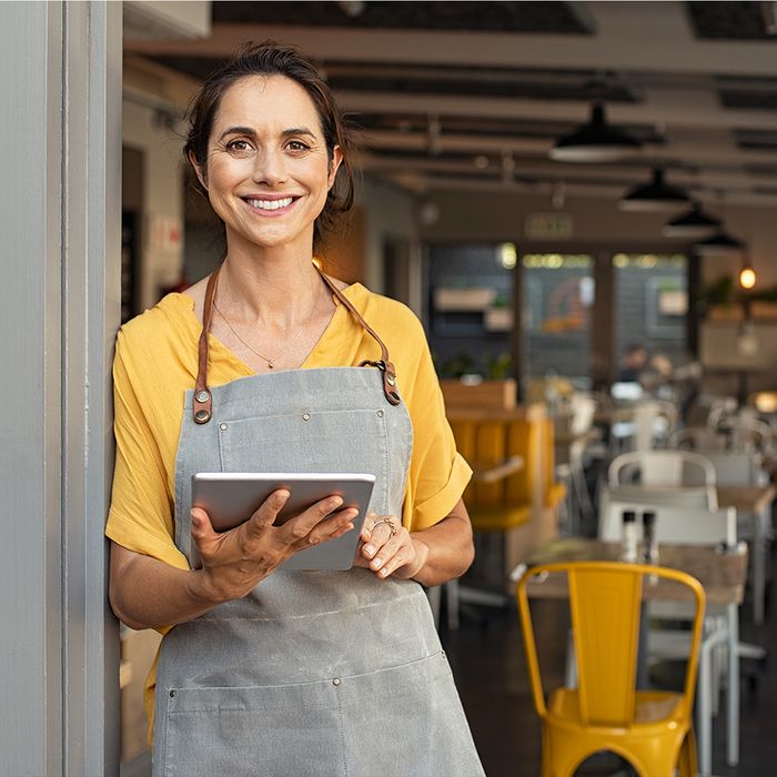 restaurant owner holding tablet