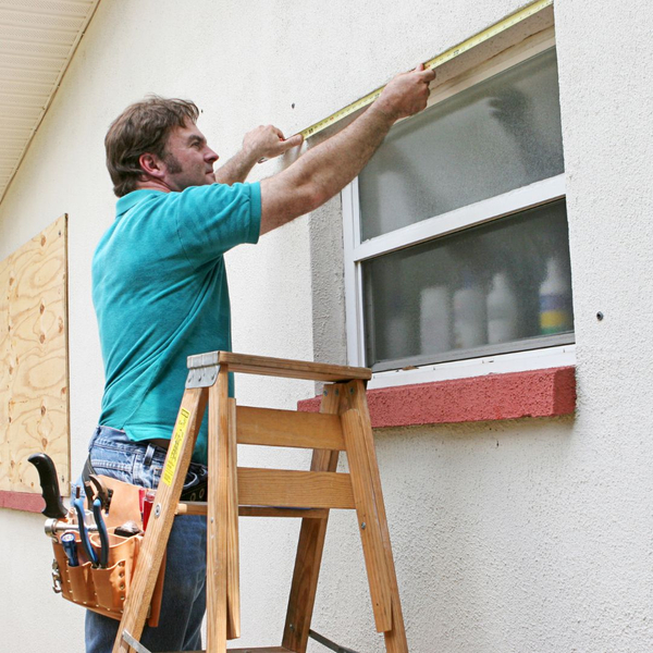 a man measuring a window Why Measurements Matter (5).jpg