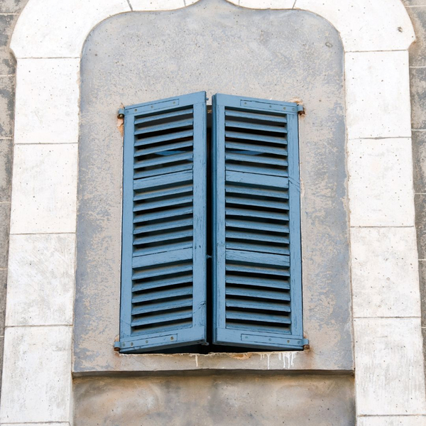 Blue shutters on stone building