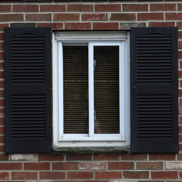 Black exterior window shutters.
