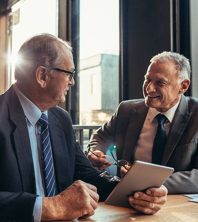 Two older businessmen talking