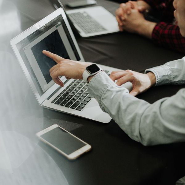 man pointing at computer