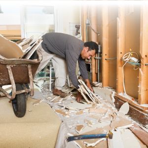 man gathering construction debris man gathering construction debris