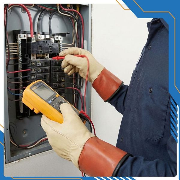 Electrician testing breakers in electrical panel with a volt-ohm meter