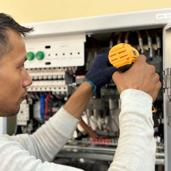 An electrician identifying a hazardous frayed electrical wire during an inspection. image1 (5).jpg
