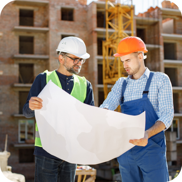 two construction workers looking at blueprints