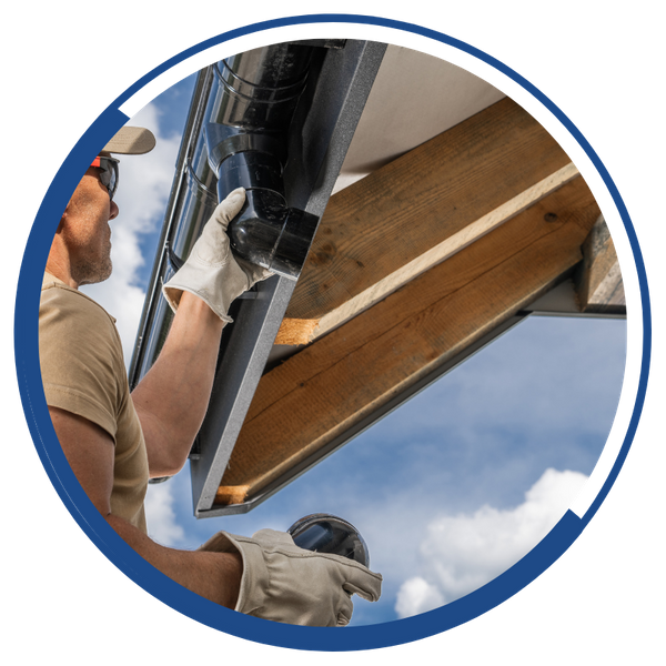 A contractor installing a gutter system on a home