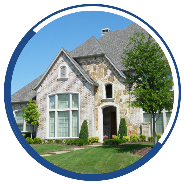 The exterior of a grand home with large windows