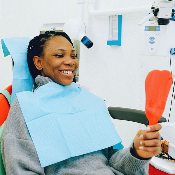 woman looking at her smile at the dentist