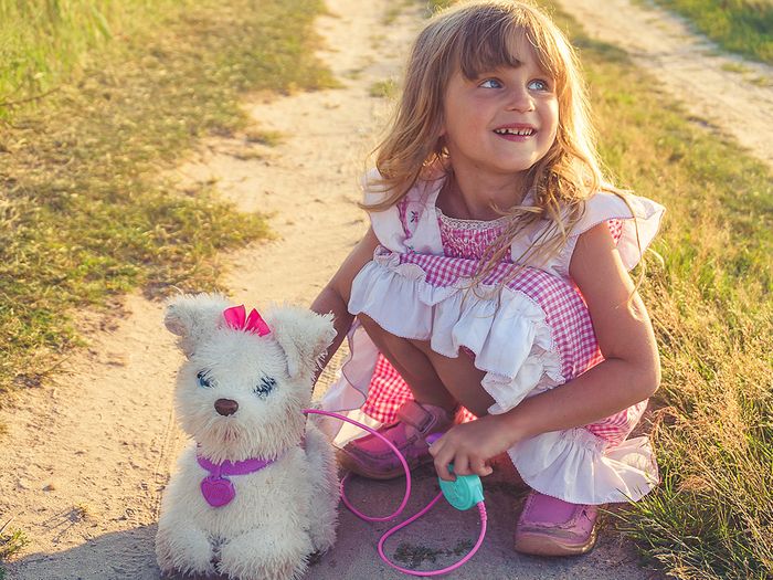 little girl with toy dog